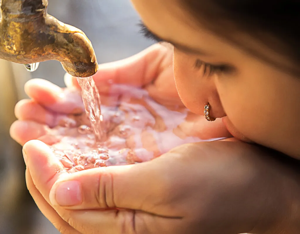 girl drinking clean water from tap